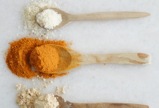 Three spoons with different types of spices on them