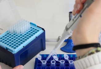 A scientist uses a pipette in a laboratory.