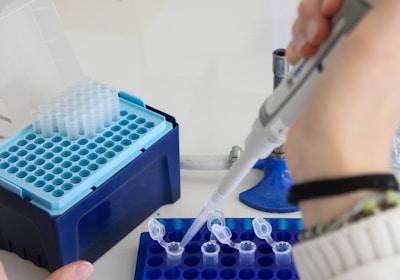 A scientist uses a pipette in a laboratory.